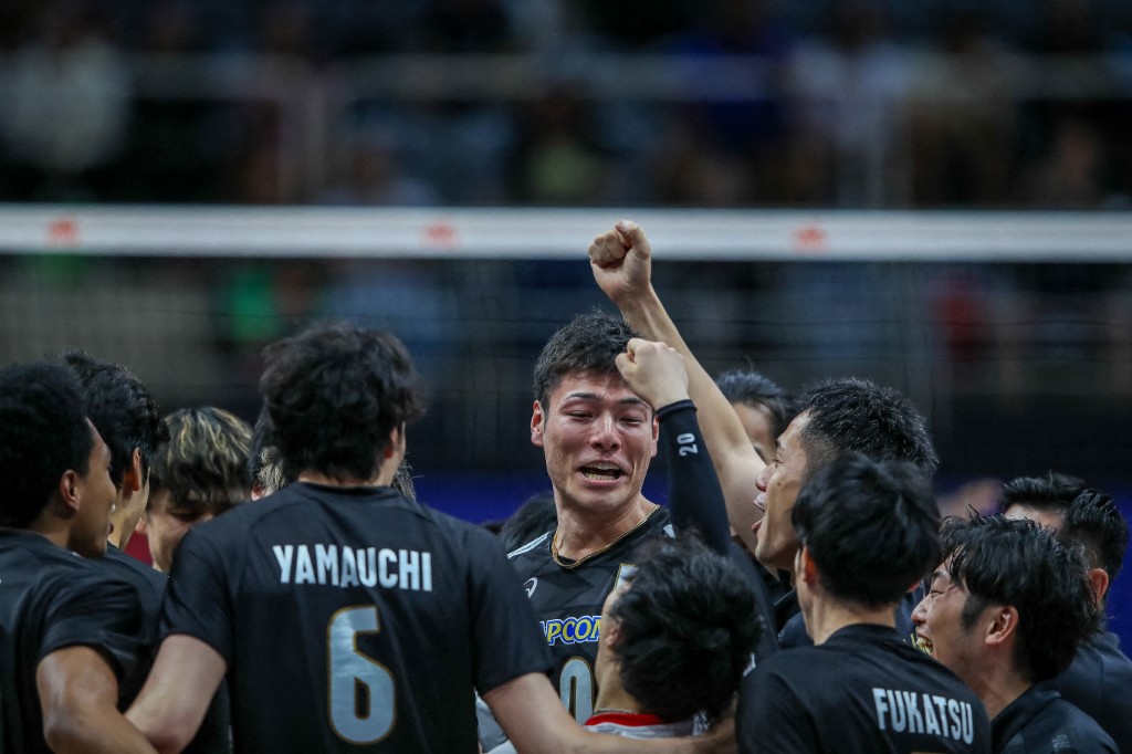 The Japanese team celebrates the win during a Pool 2 volleyball match between Cuba and Japan as part of the Men's Volleyball Nations League at Maracanazinho in Rio de Janeiro, Brazil, on May 24, 2024. (Photo by Hossein / Middle East Images / Middle East Images via AFP)